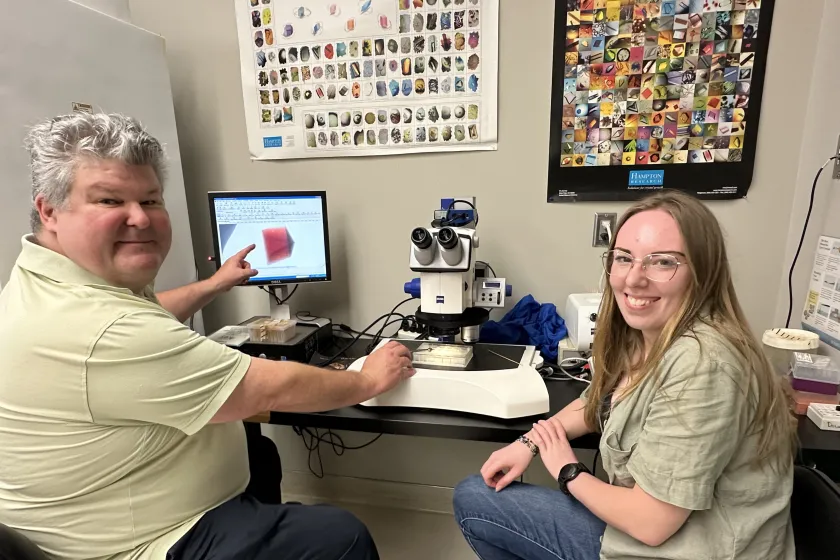 Professor Colbert and a research assistant show results on a computer screen