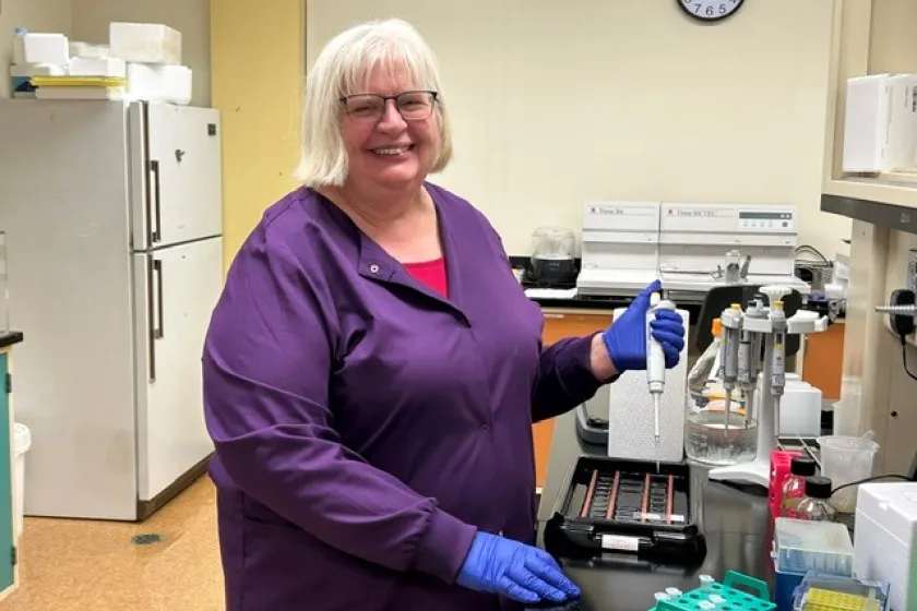 Lab manager demonstrates equipment.
