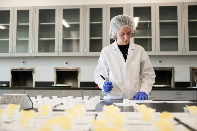 student in Food Science tests food items in the lab