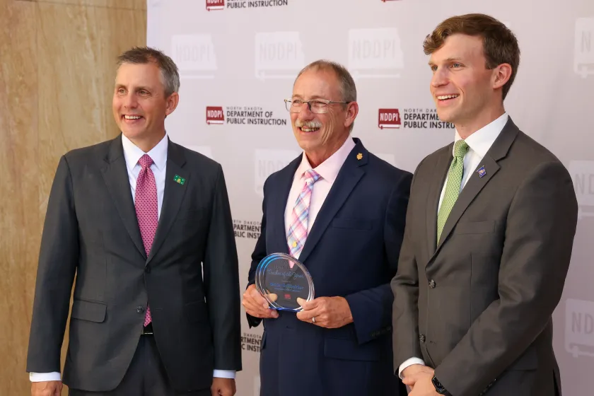 North Dakota Governor Kelly Armstrong, ND Teacher of the Year Brian Schneider and State Superintendent Levi Bachmeier. 
