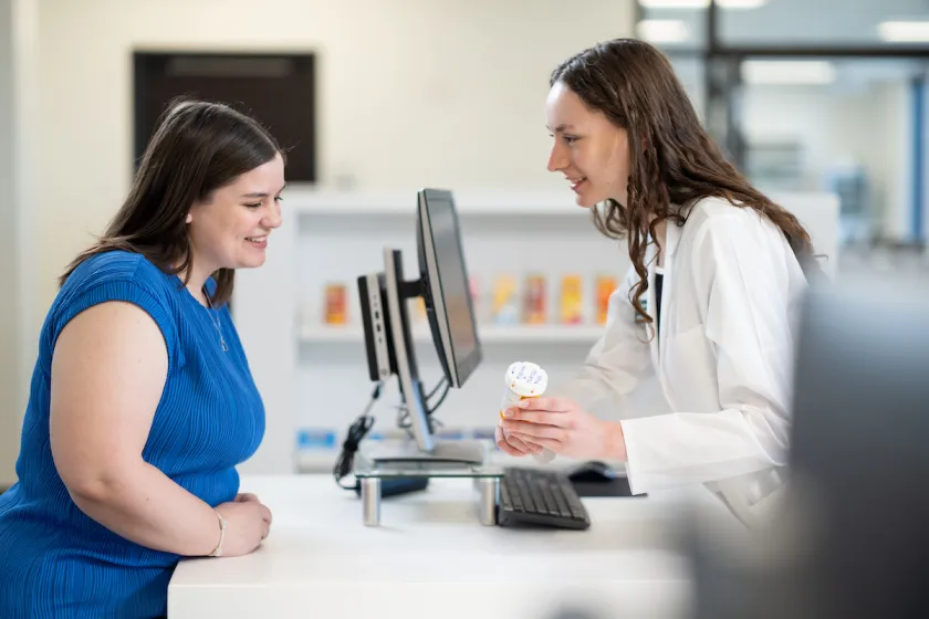 An NDSU PharmD student practices counseling a client on medication.