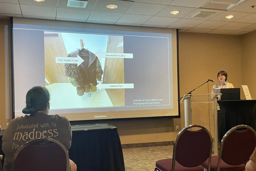 Student presenting at podium.