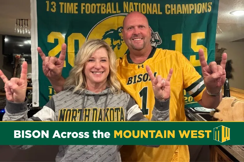 pharmacy graduates Jerrod and Brenda Milton wearing Bison gear and giving Bison horns