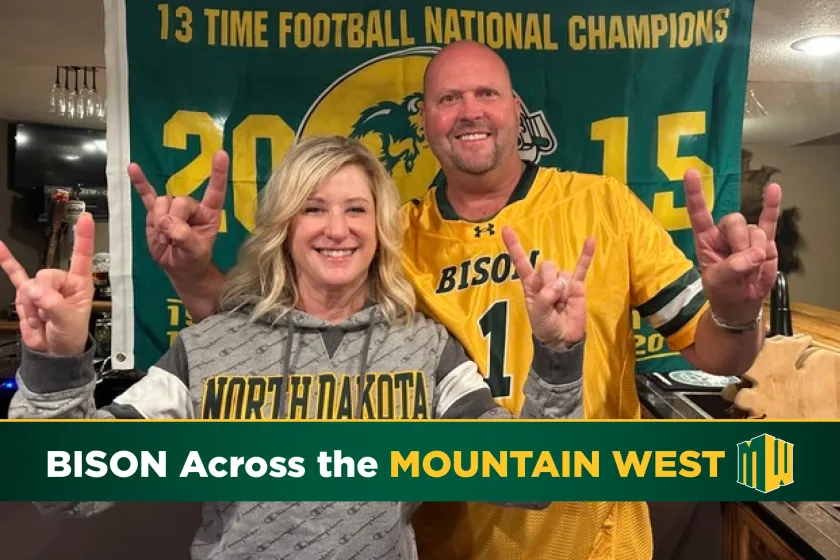 pharmacy graduates Jerrod and Brenda Milton wearing Bison gear and giving Bison horns