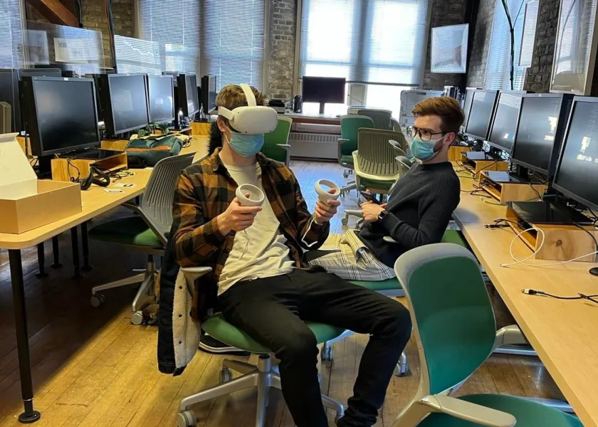 Student using Oculus while one watches.