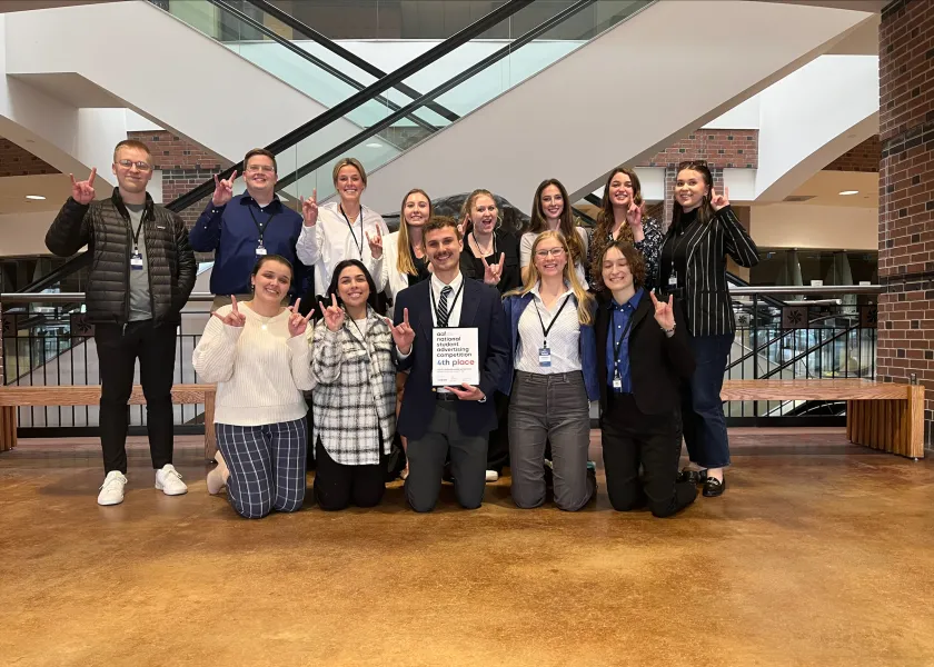 Students smiling confidently at camera.