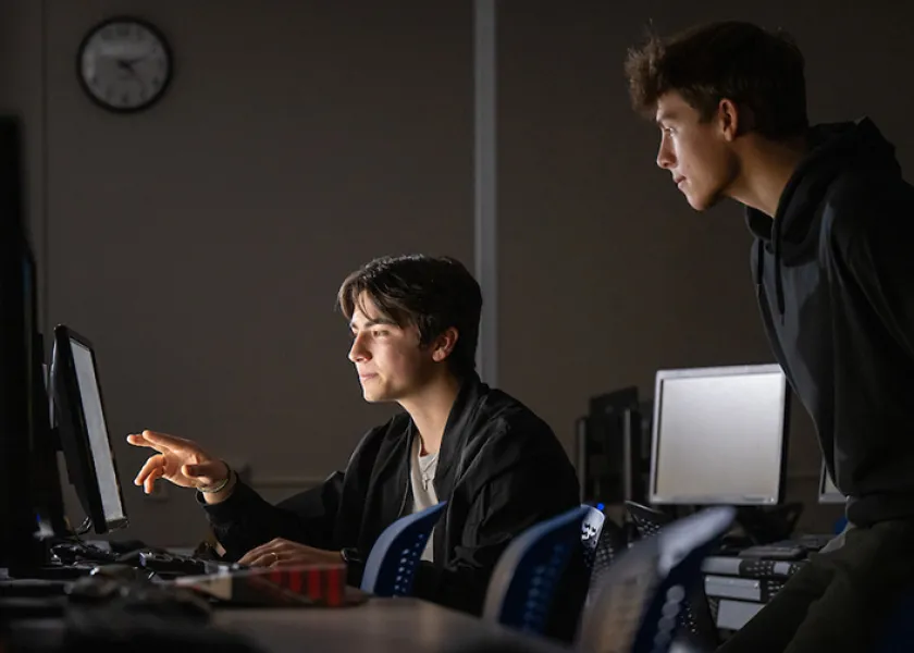 students in cybersecurity class working together in computer lab