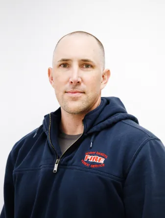 A man in a hoodie grinning