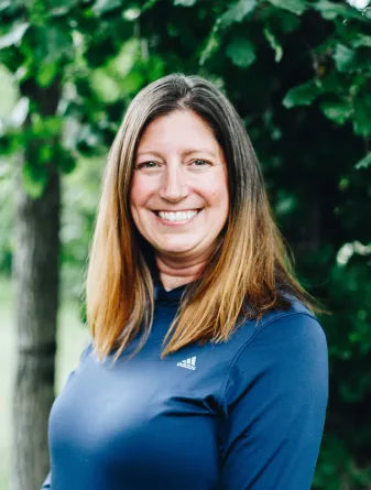 A woman with medium length brown hair smiles