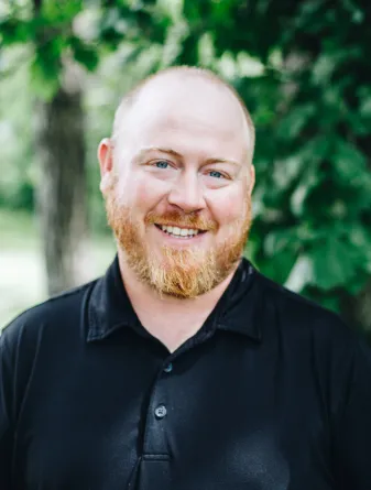 A man with a beard smiles