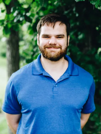 A man with a beard smiles