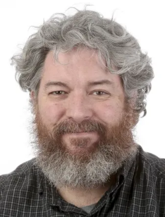 John Lamb smiling confidently at camera.