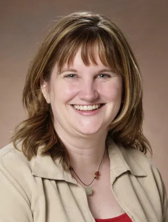 Linda Langley smiling confidently at camera.