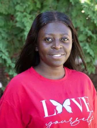 Elizabeth is smiling at the camera.