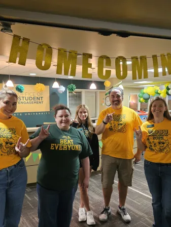 NDSU staff stand in front of their festive Homecoming decorations