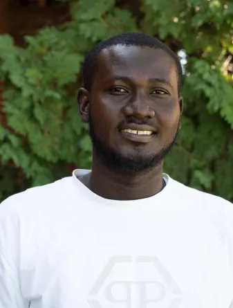 Samuel is smiling at the camera.