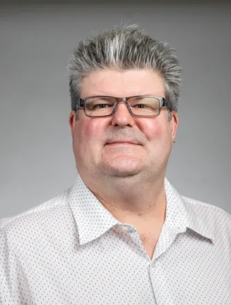 Chris Colbert looking confidently at camera.