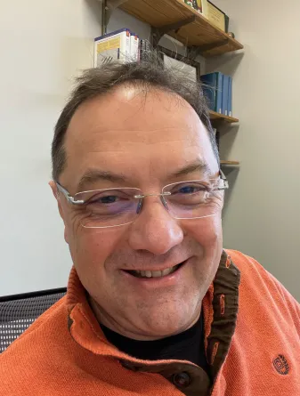 Angel Ugrinov smiling confidently at the camera