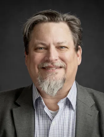 Dr. Clayton Hilmert confidently staring at the camera