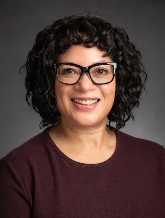 Nadeje Alexandre smiling confidently at camera. 