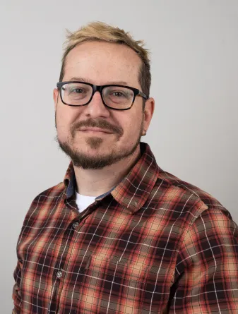 Anthony Faris looking confidently at the camera and smiling