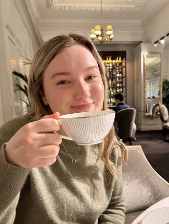 Student holding classic tea cup