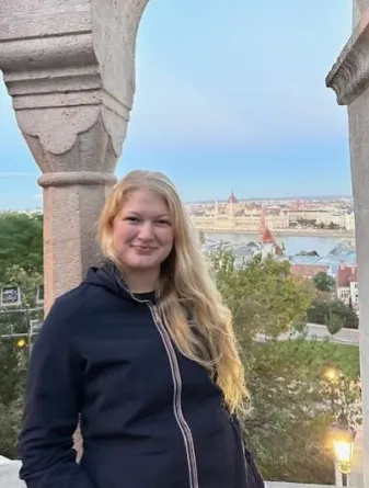 Student in front of scenic view of European skyline