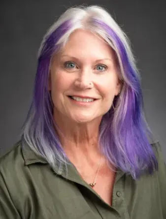 Hackerott smiling confidently at camera.