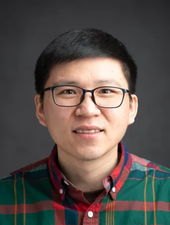 A man wearing glasses smiling