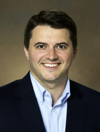 Man in blue shirt and black jacket