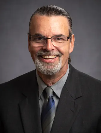 Man in blue shirt and black jacket