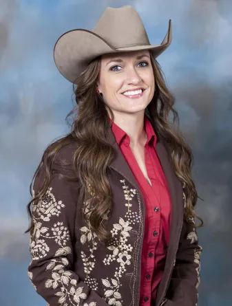 Woman in a brown jacket and cowboy hat