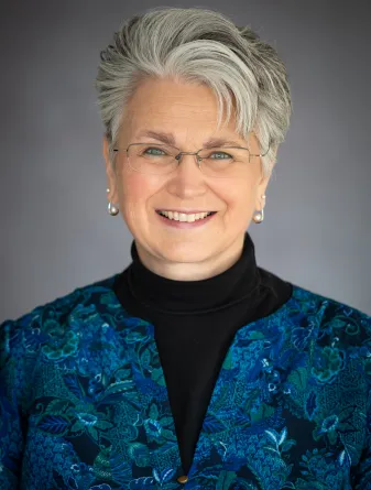 Woman in black shirt and blue jacket