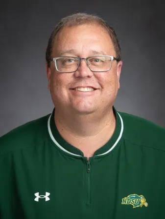 Rian nostrum headshot, wearing green ndsu pullover windbreak