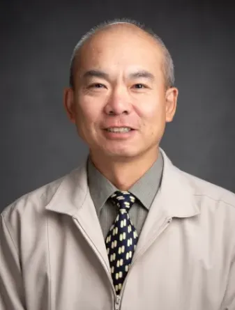 Man in tan jacket and tie