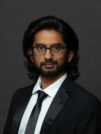 Atik Rahman looks pleasantly and confidently into the camera.