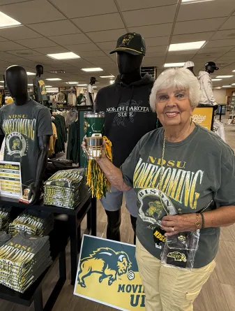 NDSU Bookstore model showing options for Homecoming swag: find shirts, accessories and more
