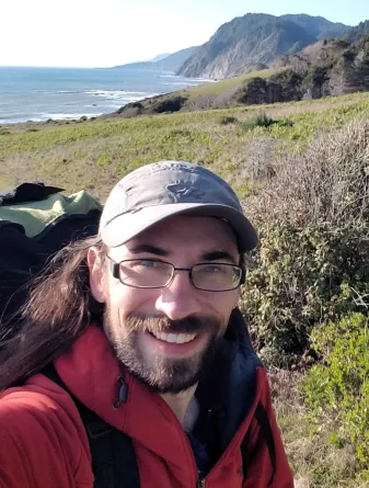 Andre Szejner-Sigal smiling confidently.