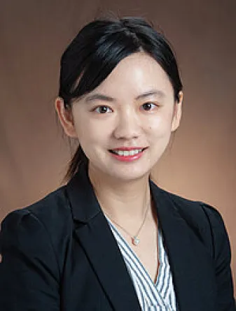 Shuning Lu smiling confidently at camera. 