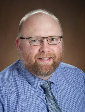 Stuart Haring smiling confidently at the camera