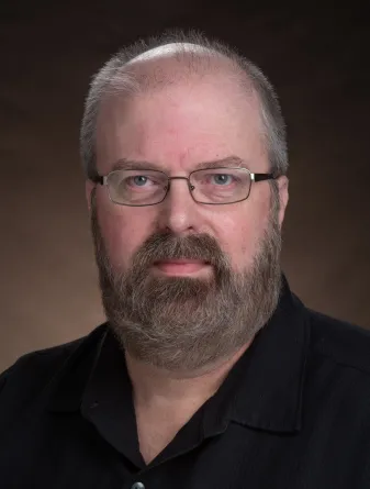 Seth Rasmussen smiling confidently at the camera