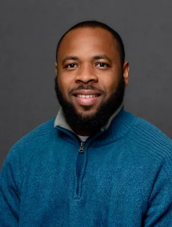 Dadzie smiling at the camera