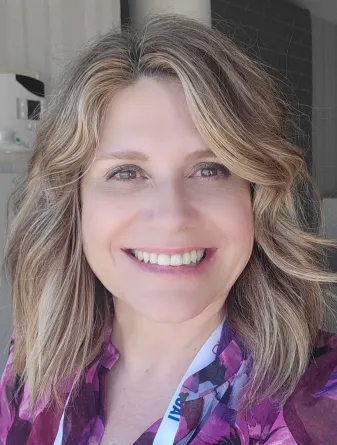 Archbold smiling confidently at camera.