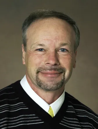 Thompson smiling confidently at camera.