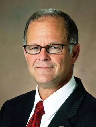 Bresciani smiling confidently at camera