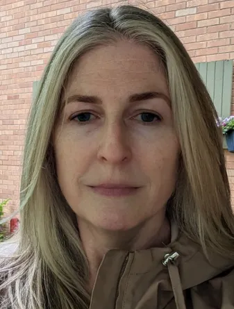 Graham-Bertolini smiling confidently at camera.