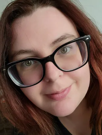  Ashleah Wimberly smiling confidently at camera.