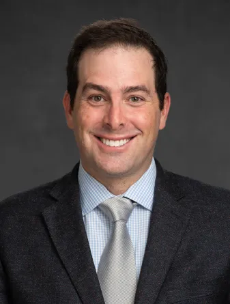 Adam Goldwyn smiling confidently at camera.