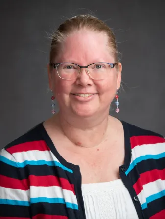 Deona McEnery smiling confidently at camera.