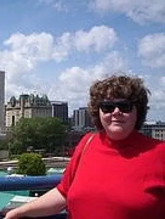 Kaye Temanson smiling confidently at camera.